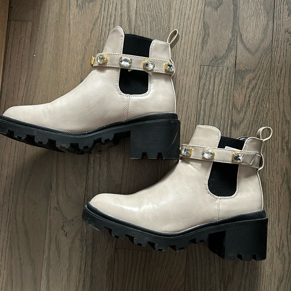 Beige boots with removable gem buckle.
